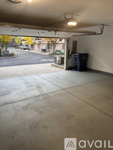 A view of a parking garage with a blue trash can.