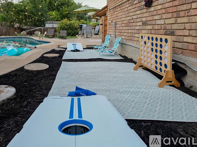 A pool with a slide and a poolside table.