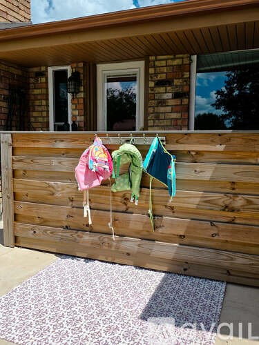 A wooden fence with clothes hanging on it.
