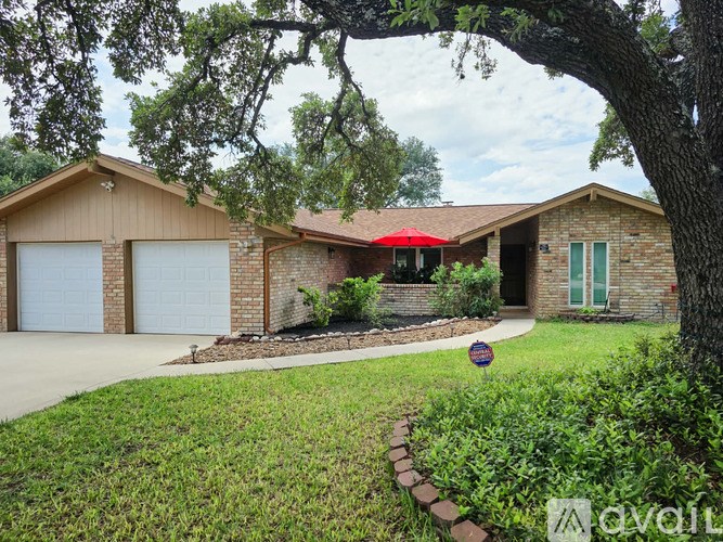 A house with a red awning and a brick exterior.