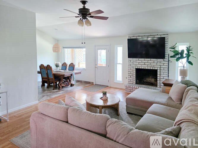 A living room with a fireplace and a television.