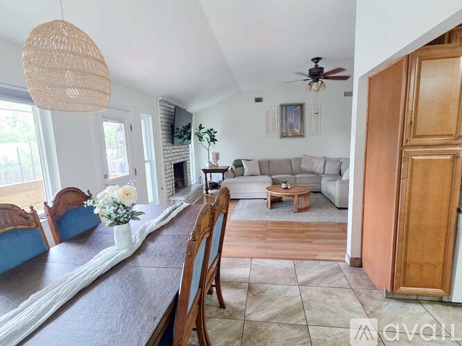 A living room with a couch, chairs, and a coffee table.