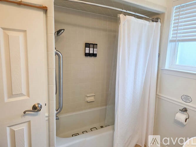 A white bathroom with a tub and shower.