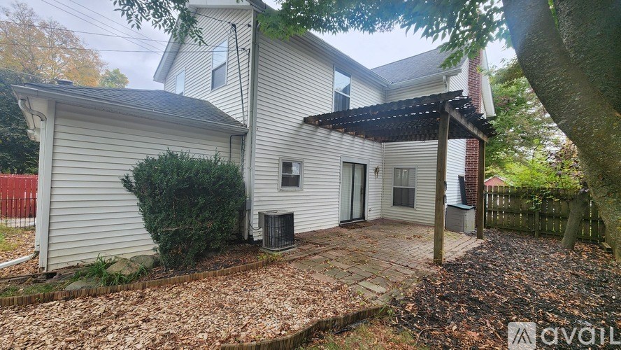A house with a covered patio is for sale.
