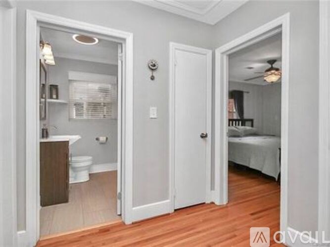 A bathroom with a toilet, sink, and mirror is shown.