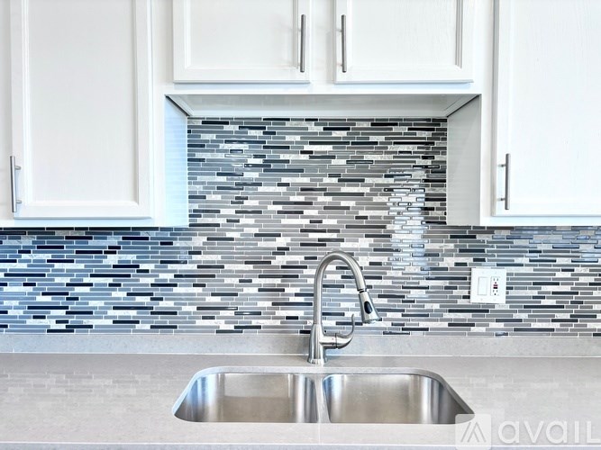 A kitchen with a sink and cabinets.