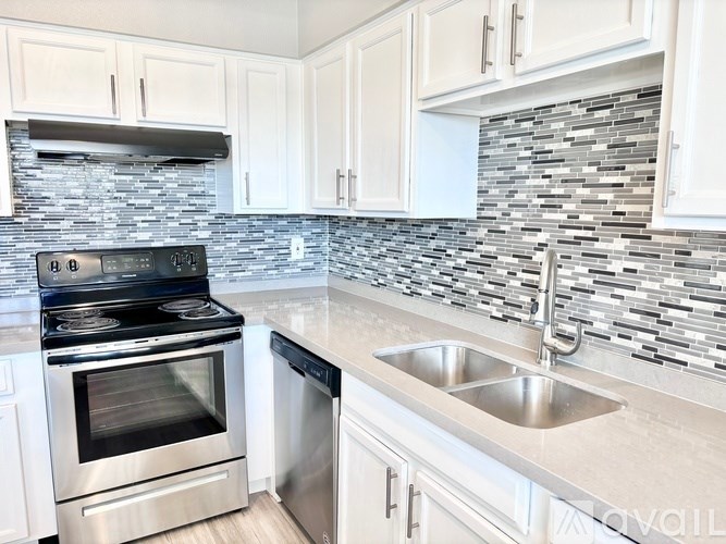 A modern kitchen with a stove, oven, and sink.