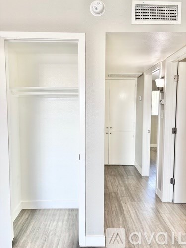 A white door is open to a hallway.