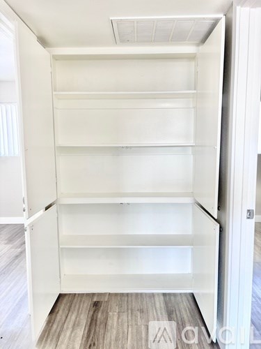 Empty white shelves in a room.