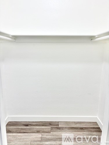 A room with a wooden floor and white walls.