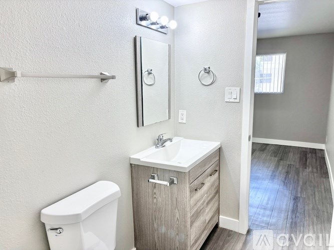 A white toilet sits next to a sink in a bathroom.
