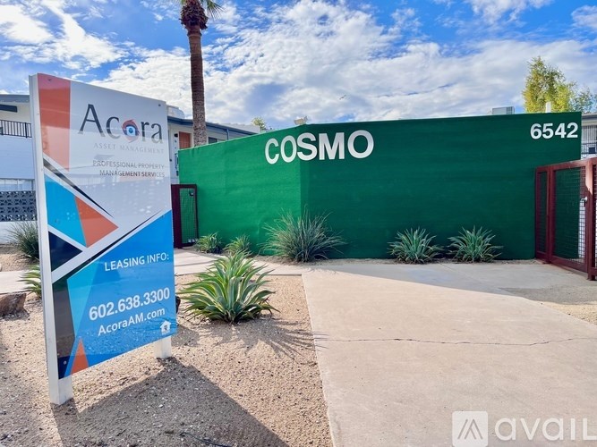 A green sign with the word COSMO on it.