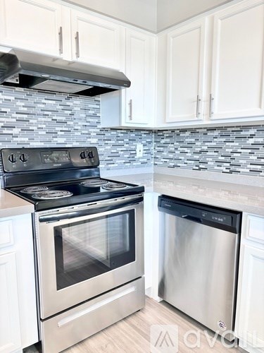 A kitchen with a stove and an oven.