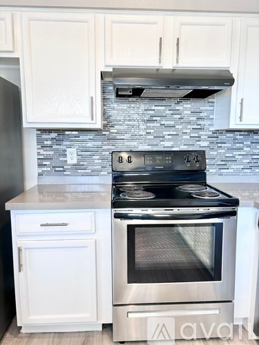 A kitchen with a stove and oven built into the counter.