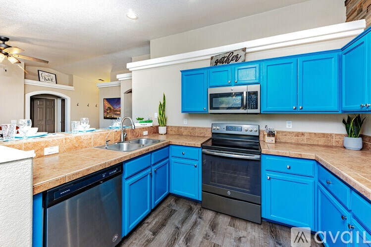 A kitchen with blue cabinets and appliances.