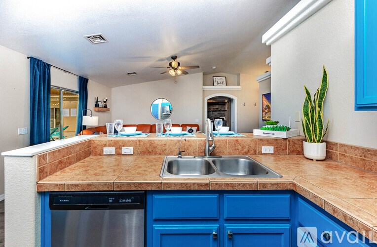 A kitchen with blue cabinets and a brown countertop.