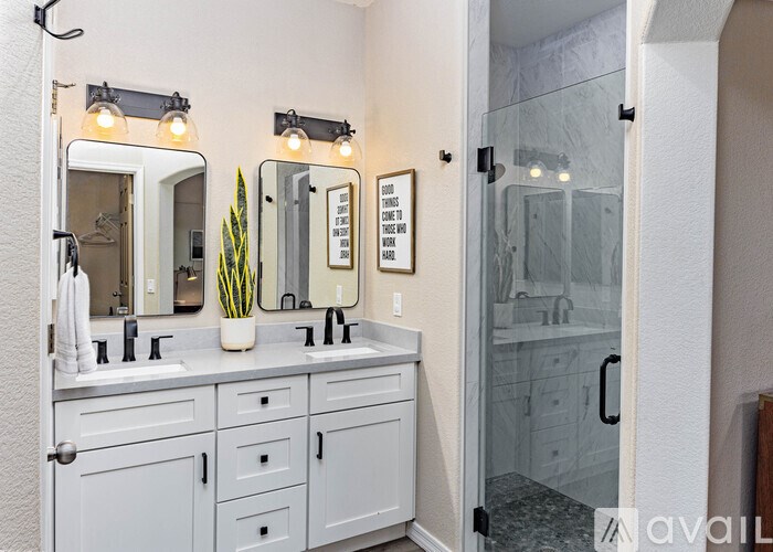 A bathroom with a white vanity and a mirror above it.