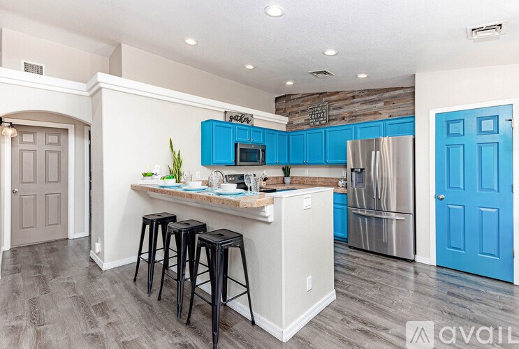 A kitchen with a white island and blue cabinets.