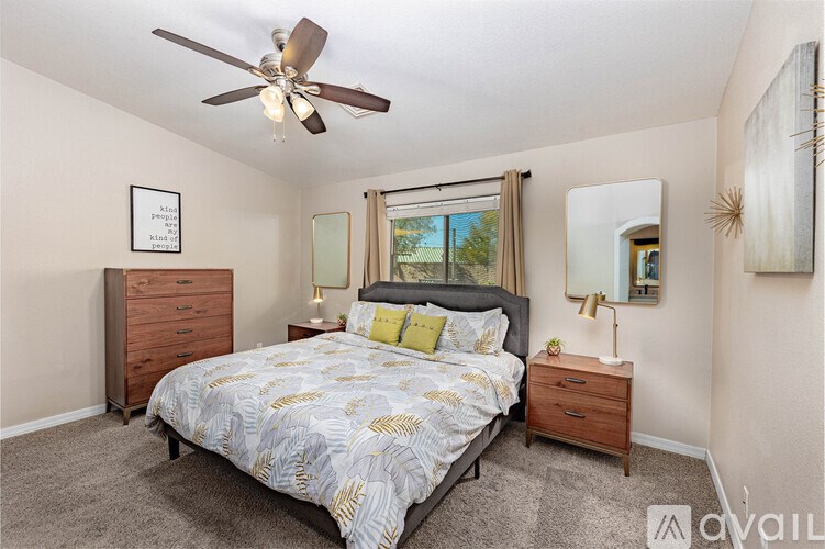 A bedroom with a bed, dresser, and mirror.
