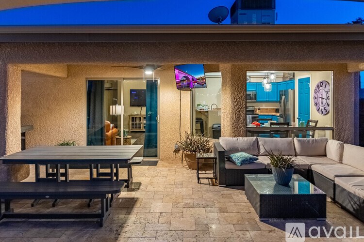 A patio with a table, chairs, and a couch.