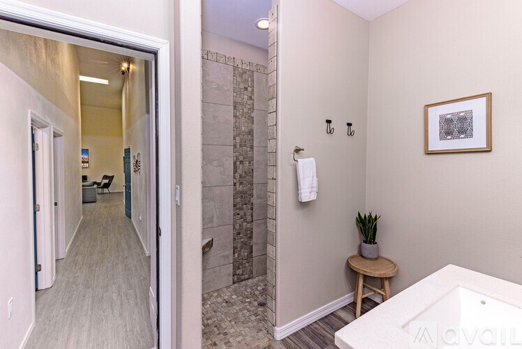 A bathroom with a tub, toilet, and sink.