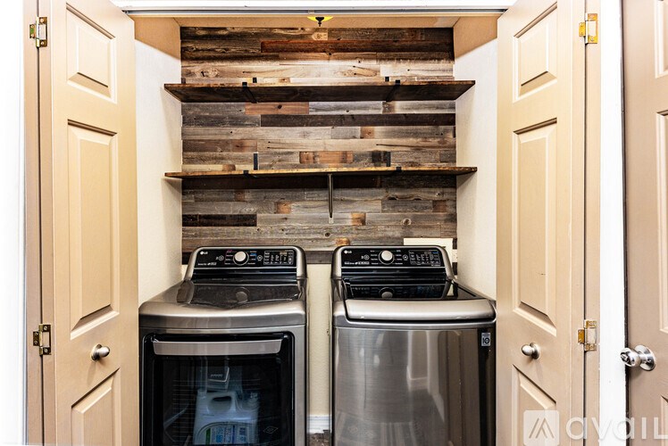 A small kitchen with a stove and oven built into a wooden wall.