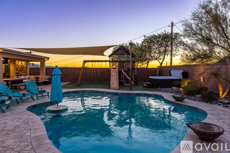 A pool with a sunset in the background.