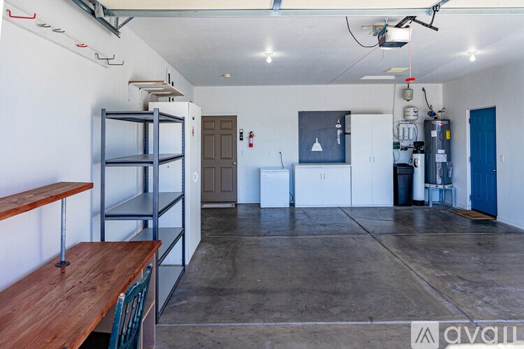 A large open room with a wooden table and shelves.