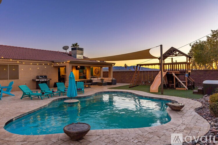 A backyard with a pool and a patio area.