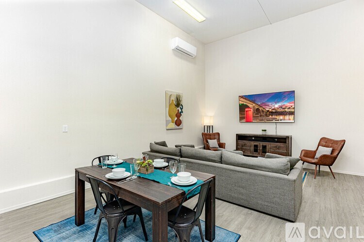 A dining table with chairs and a couch in a room.