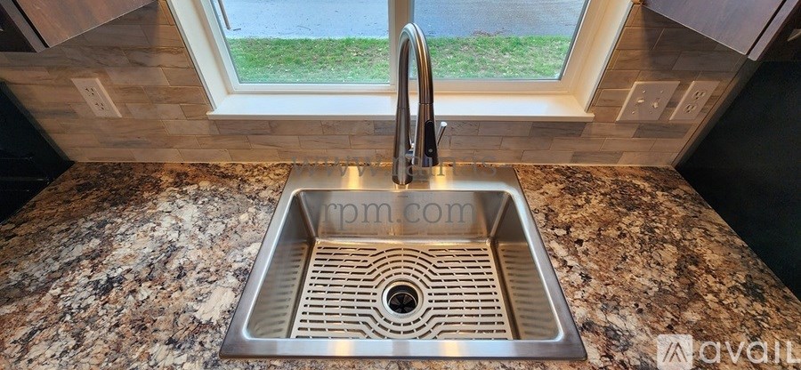 A kitchen sink with a window above it.