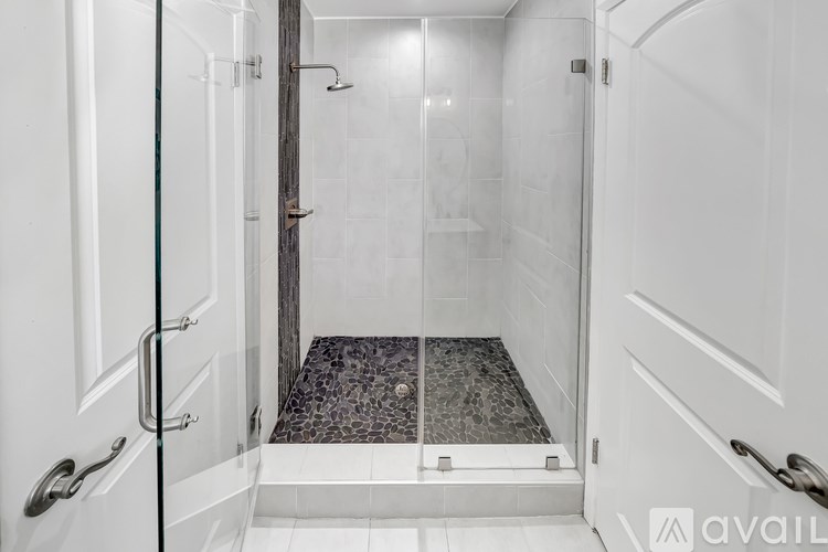 A white bathroom with a walk in shower.