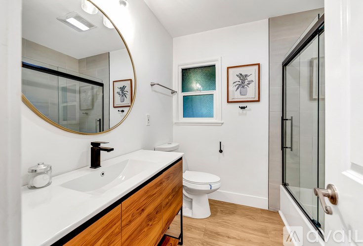 A bathroom with a white sink and a toilet.