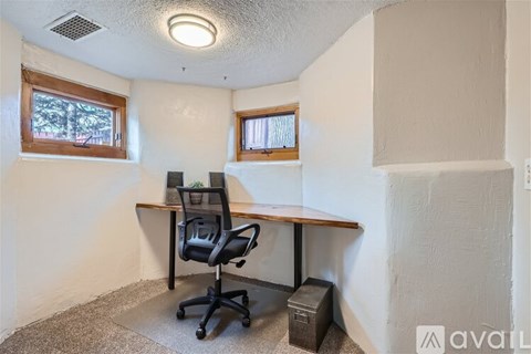 A room with a desk and a chair.