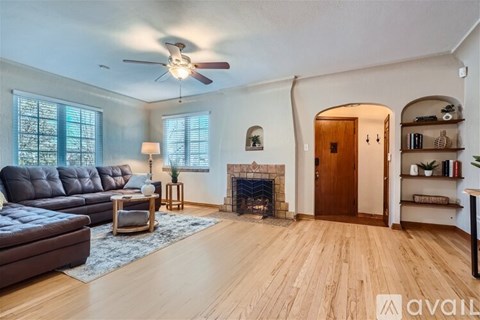 A living room with a fireplace and a couch.