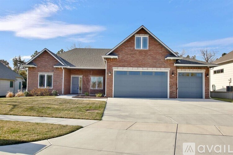 A two-story house with a garage is available for sale.