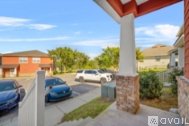 A sunny day at a residential area with houses and cars.