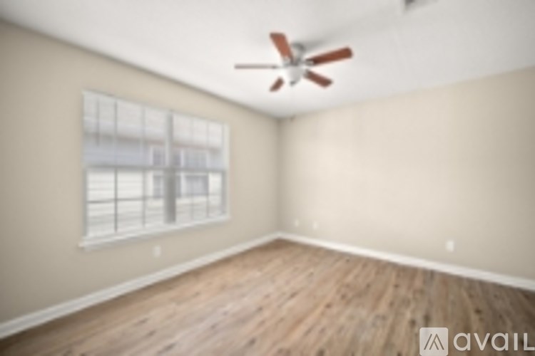 A room with a fan and a window.