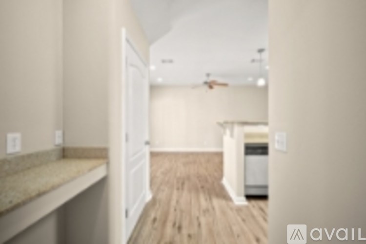 A kitchen with a white door and a counter top.