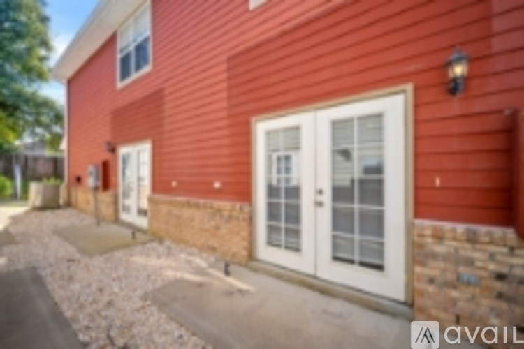 A red house with a white door and windows.