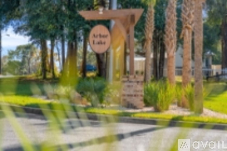 A sign for Archer Lake is displayed in front of some trees.