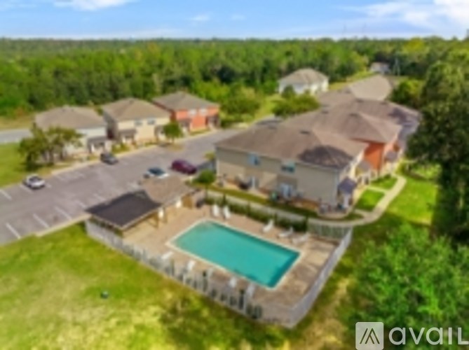 A bird's eye view of a house with a pool in the backyard.