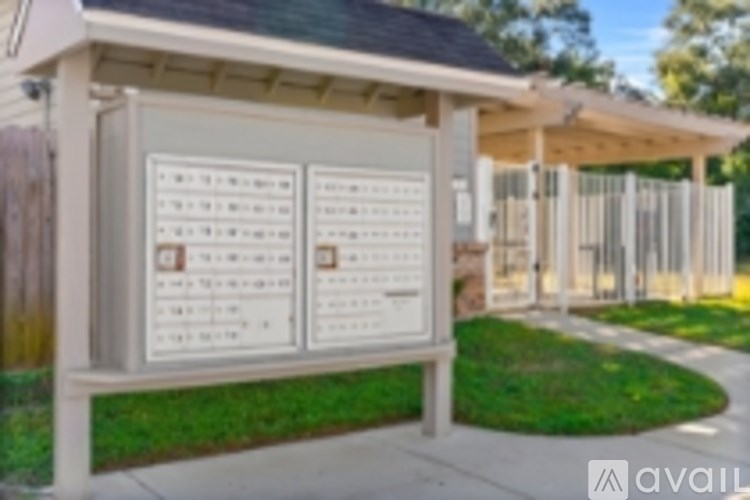 A white board with a list of items on it is in front of a building.