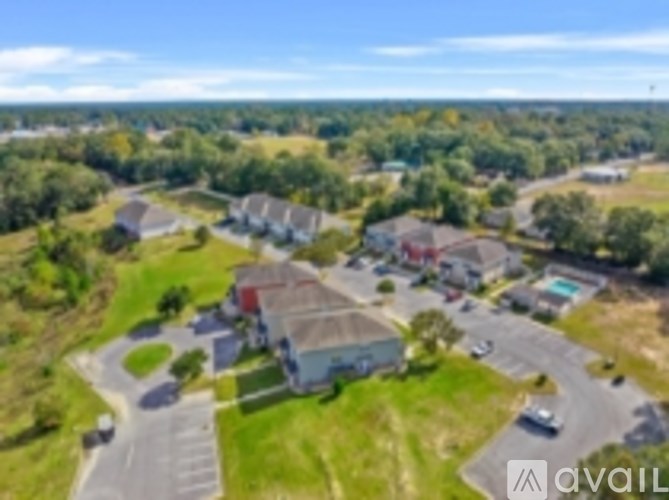A bird's eye view of a residential area with houses and cars.
