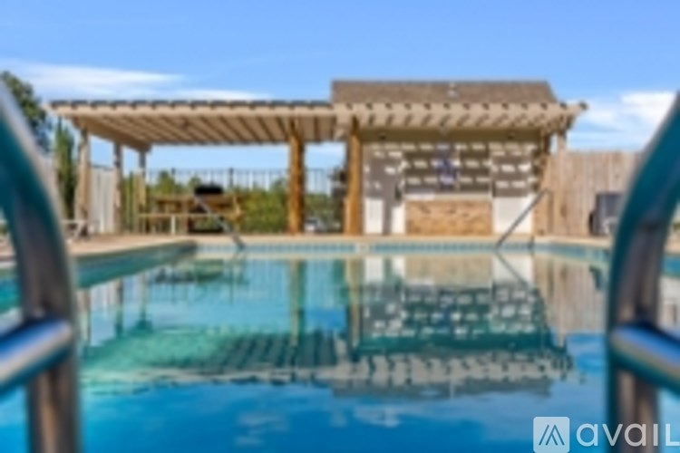 A pool with a wooden pergola over it.