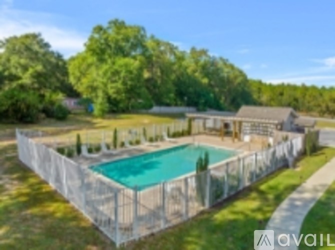 A large backyard with a pool and a fence.