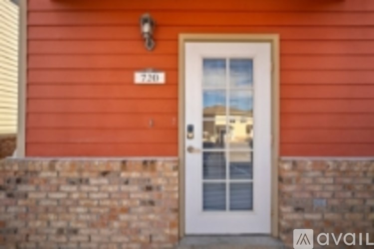 A red house with a white door and a window.