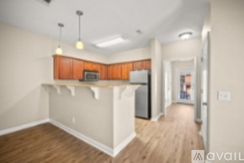 A kitchen with wooden cabinets and a refrigerator.