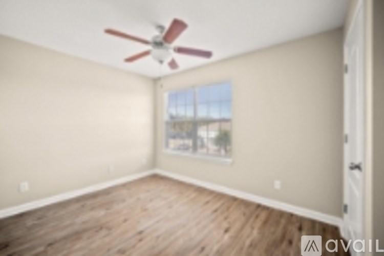 Empty room with a ceiling fan and a window.