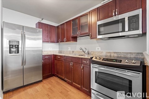 A kitchen with wooden cabinets and stainless steel appliances.